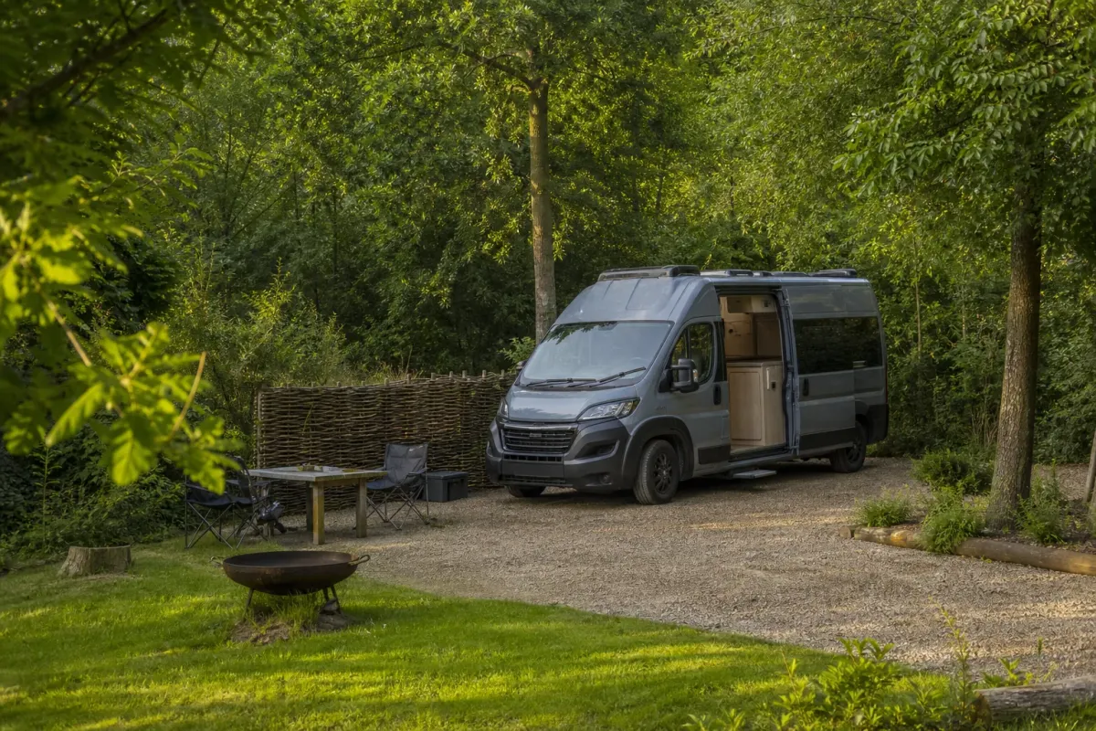 Campervan by a forest pitch